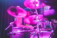 a man playing drums in a dark room