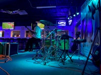 a group of people playing drums in a bar